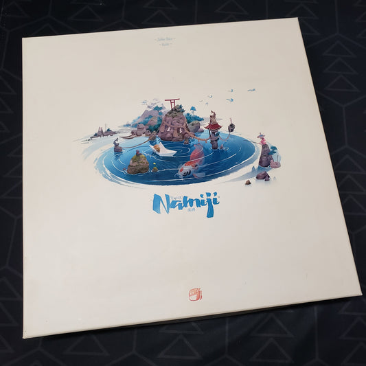 Image shows the front cover of the Deluxe Edition box for the board game Namiji