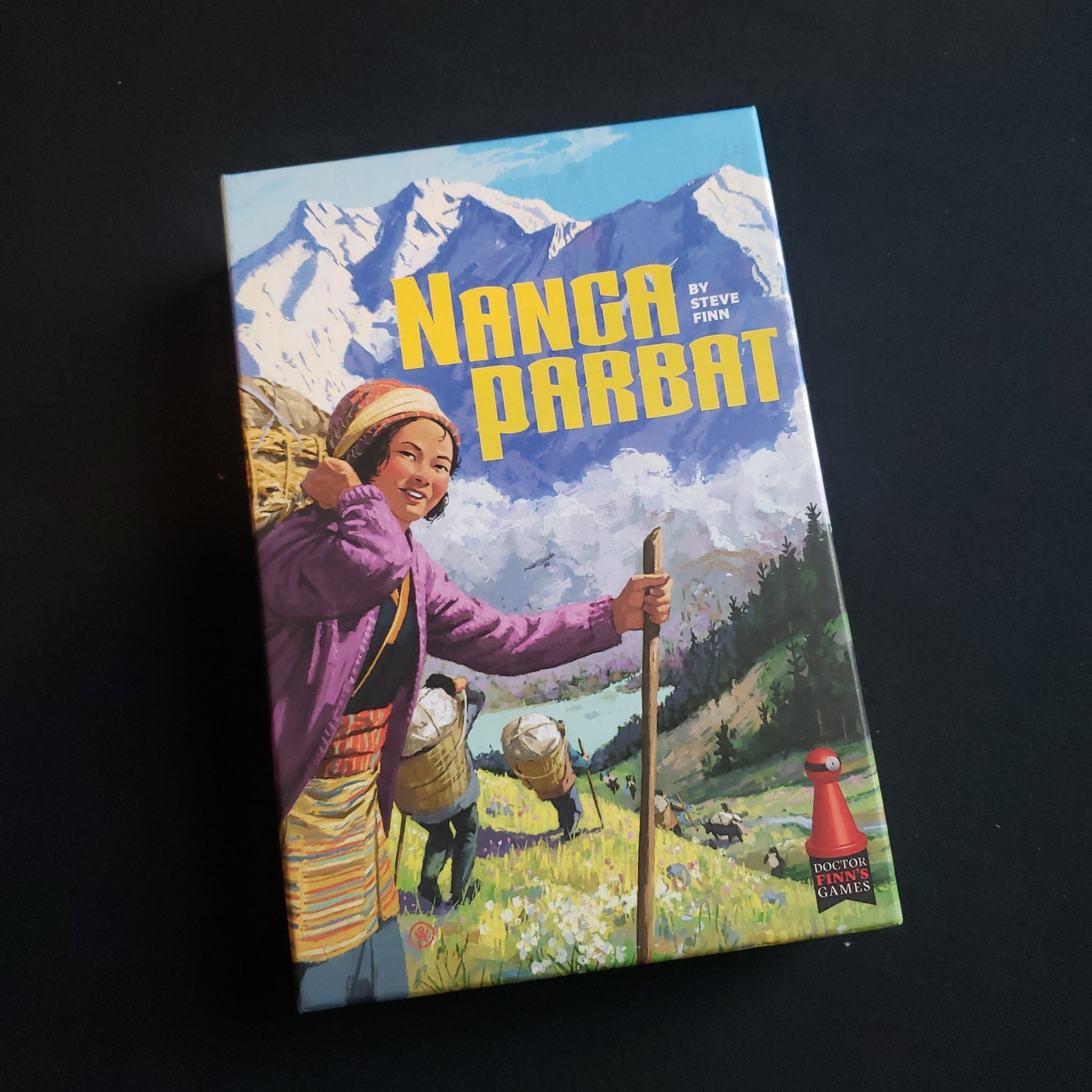 Image shows the front cover of the box of the Nanga Parbat board game