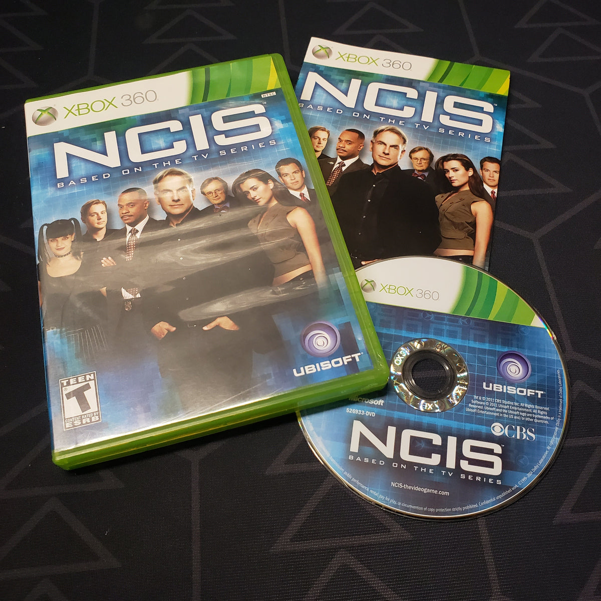 Image shows the case, manual and disc for the video game NCIS: The Game for Xbox 360