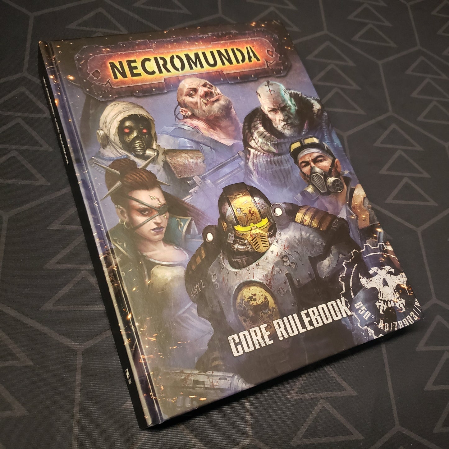 Image shows the front cover of the Necromunda: 2023 Core Rulebook wargaming book
