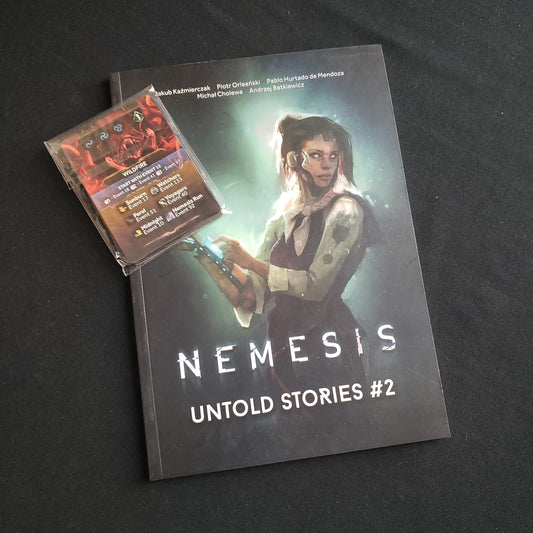 Image shows the front cover of the book and card pack for the Untold Stories #2 expansion for the board game Nemesis