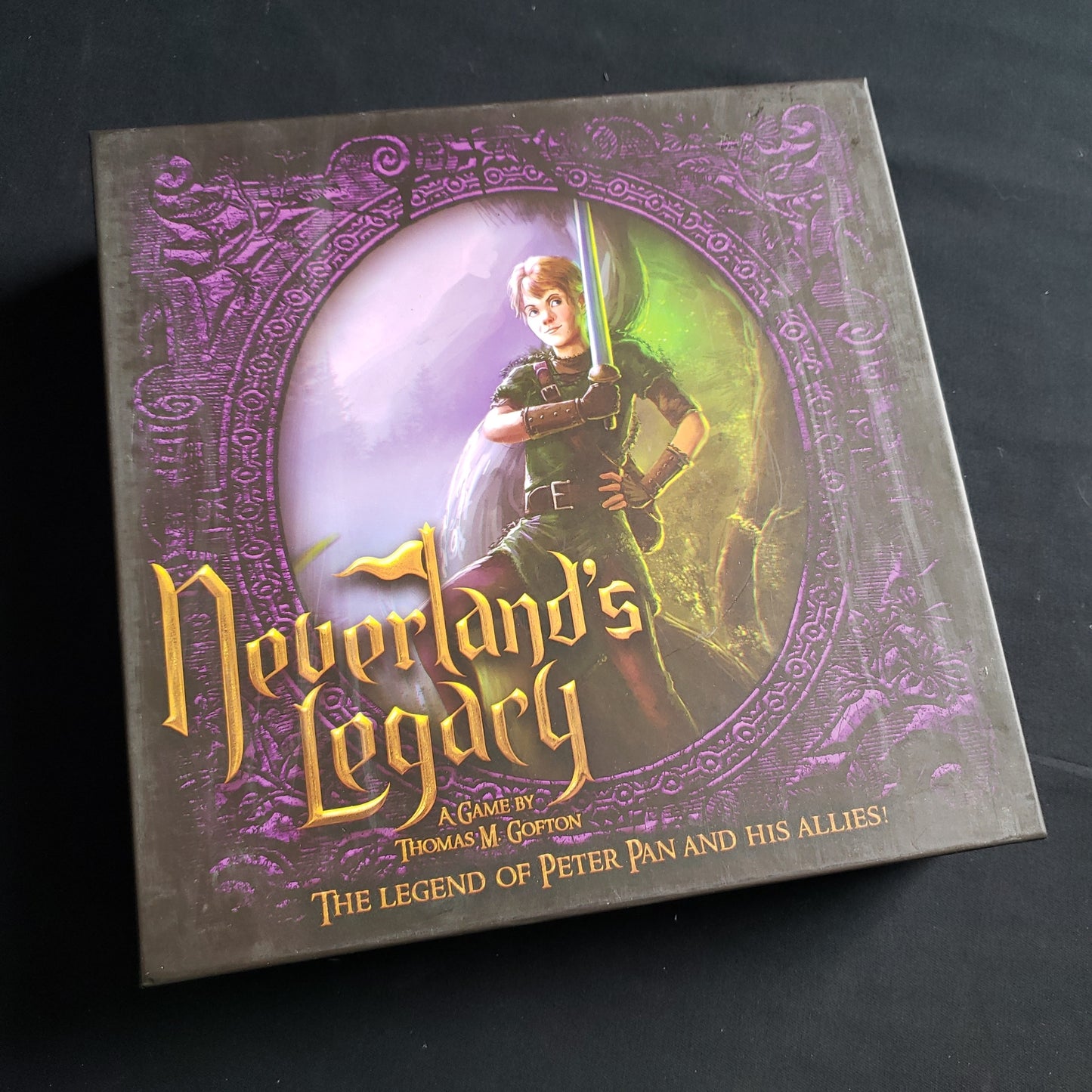 Image shows the front cover of the box of the Neverland's Legacy board game