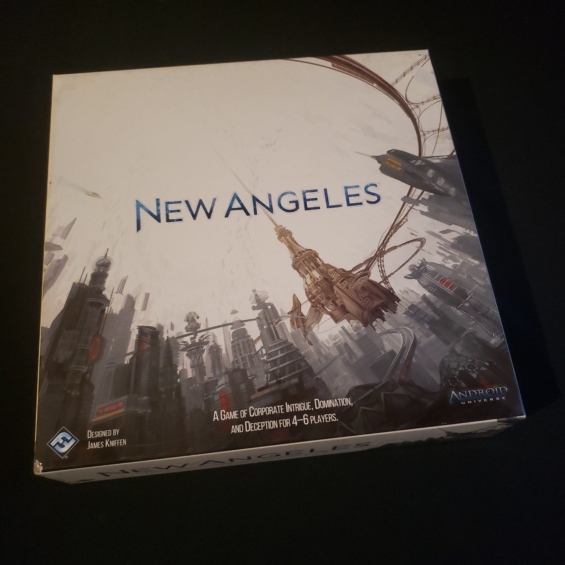 Image shows the front cover of the box of the New Angeles board game