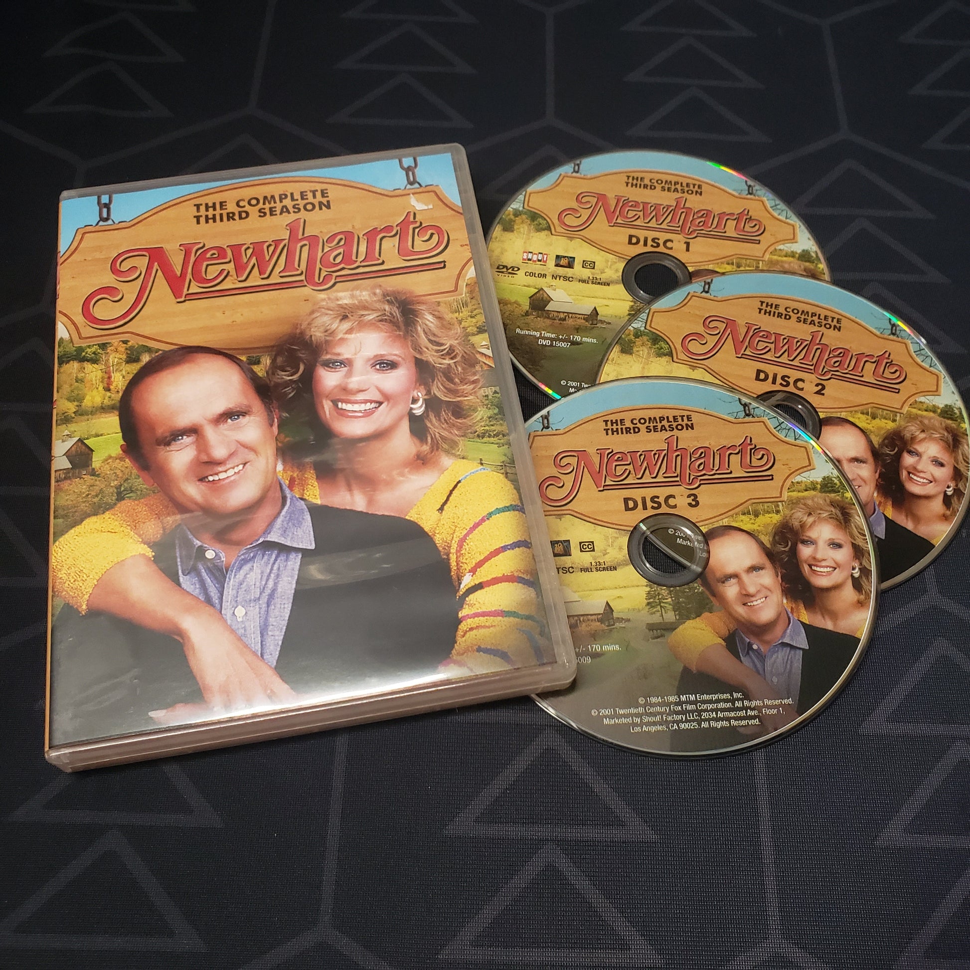 Image shows the case & three discs for Newhart: Season 3 on DVD