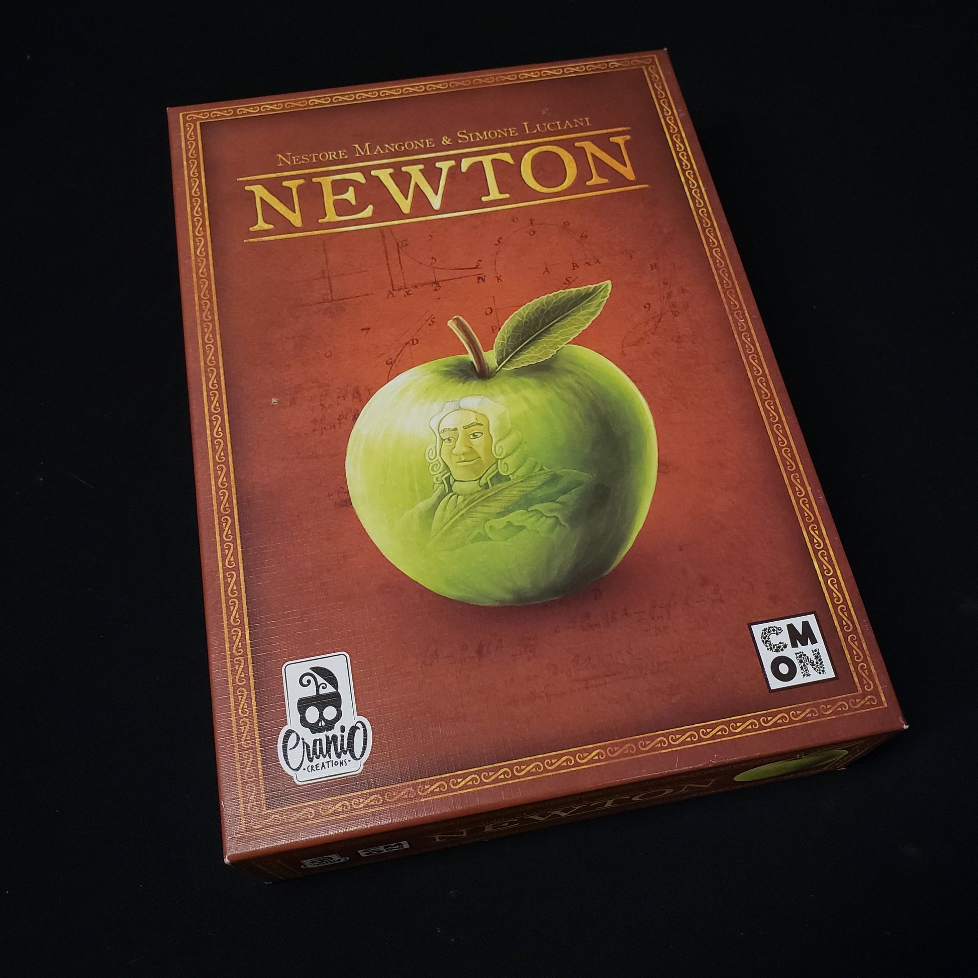 Image shows the front cover of the box of the Newton board game