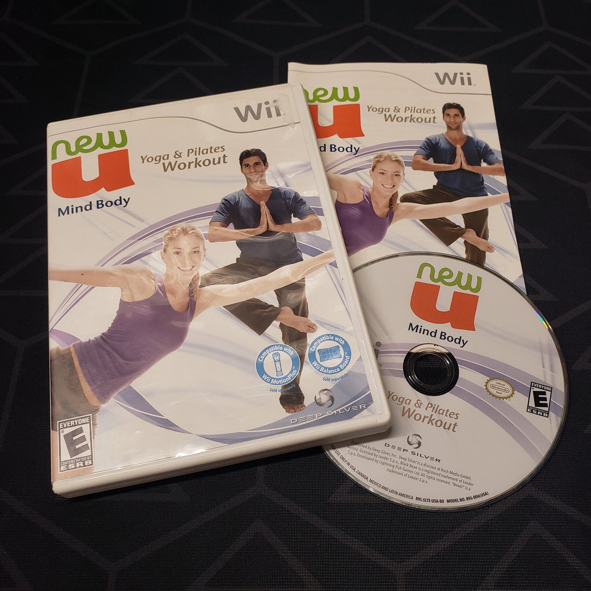 Image shows the case, manual and disc for the video game NewU Mind Body: Yoga & Pilates Workout for Nintendo Wii