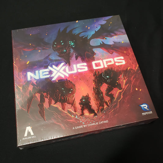 Image shows the front cover of the box of the 2024 edition of the board game Nexus Ops