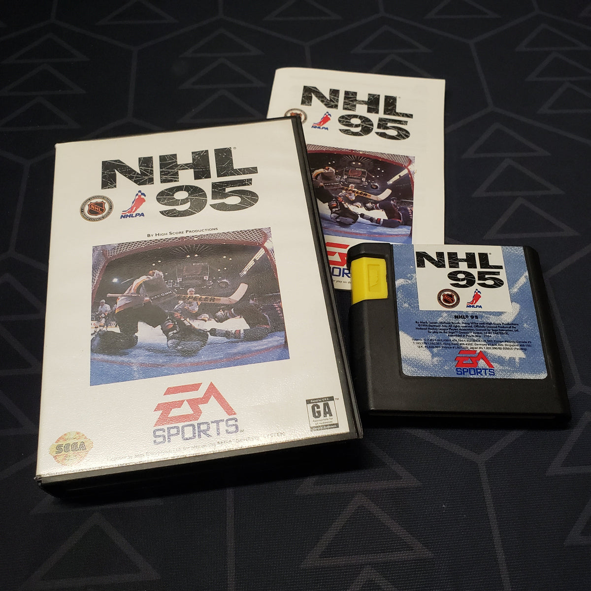 Image shows the case, manual and cartridge for the video game NHL 95 for Sega Genesis