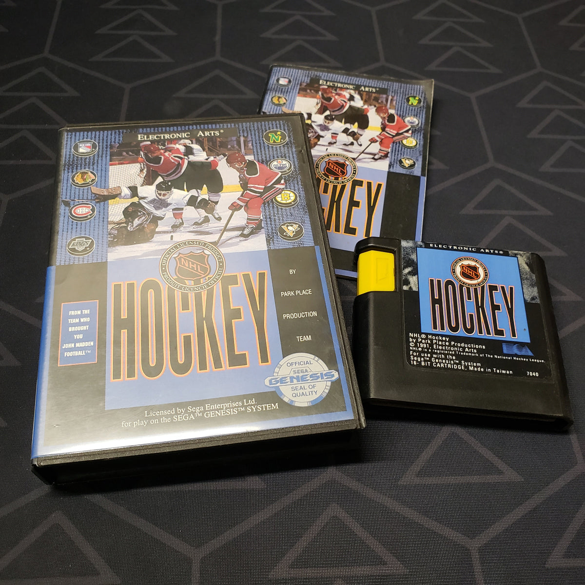 Image shows the case, manual and cartridge for the video game NHL Hockey for Sega Genesis