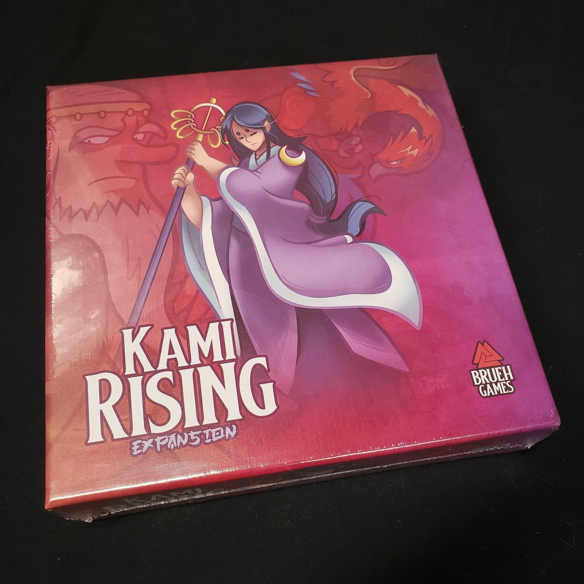 Image shows the front cover of the box of the Kami Rising expansion for the board game Night Parade of a Hunderd Yokai