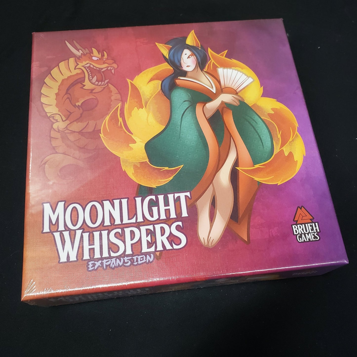 Image shows the front cover of the box of the Moonlight Whispers expansion for the board game Night Parade of a Hundred Yokai