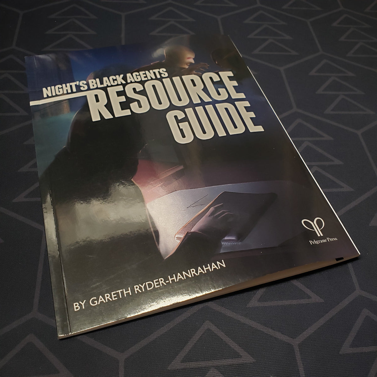 Image shows the front cover of the Resource Guide book for the roleplaying game Night's Black Agents