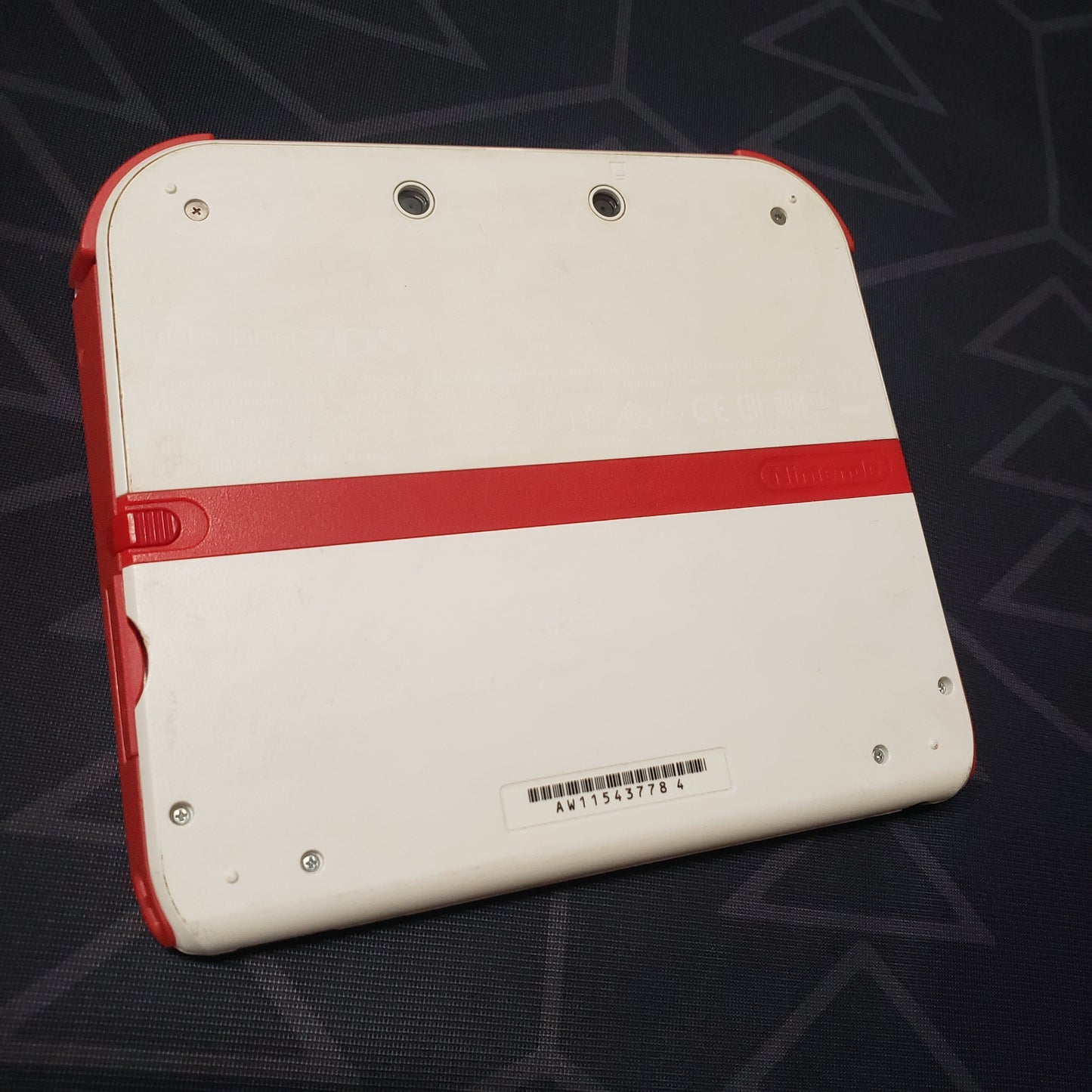Image shows the back of a Nintendo 2DS: Scarlet Red gaming console