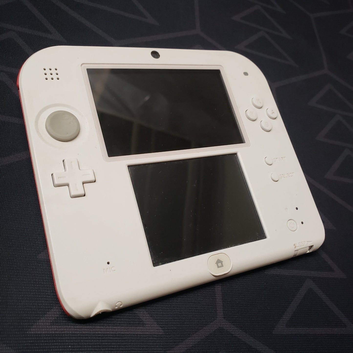Image shows the front of a Nintendo 2DS: Scarlet Red gaming console
