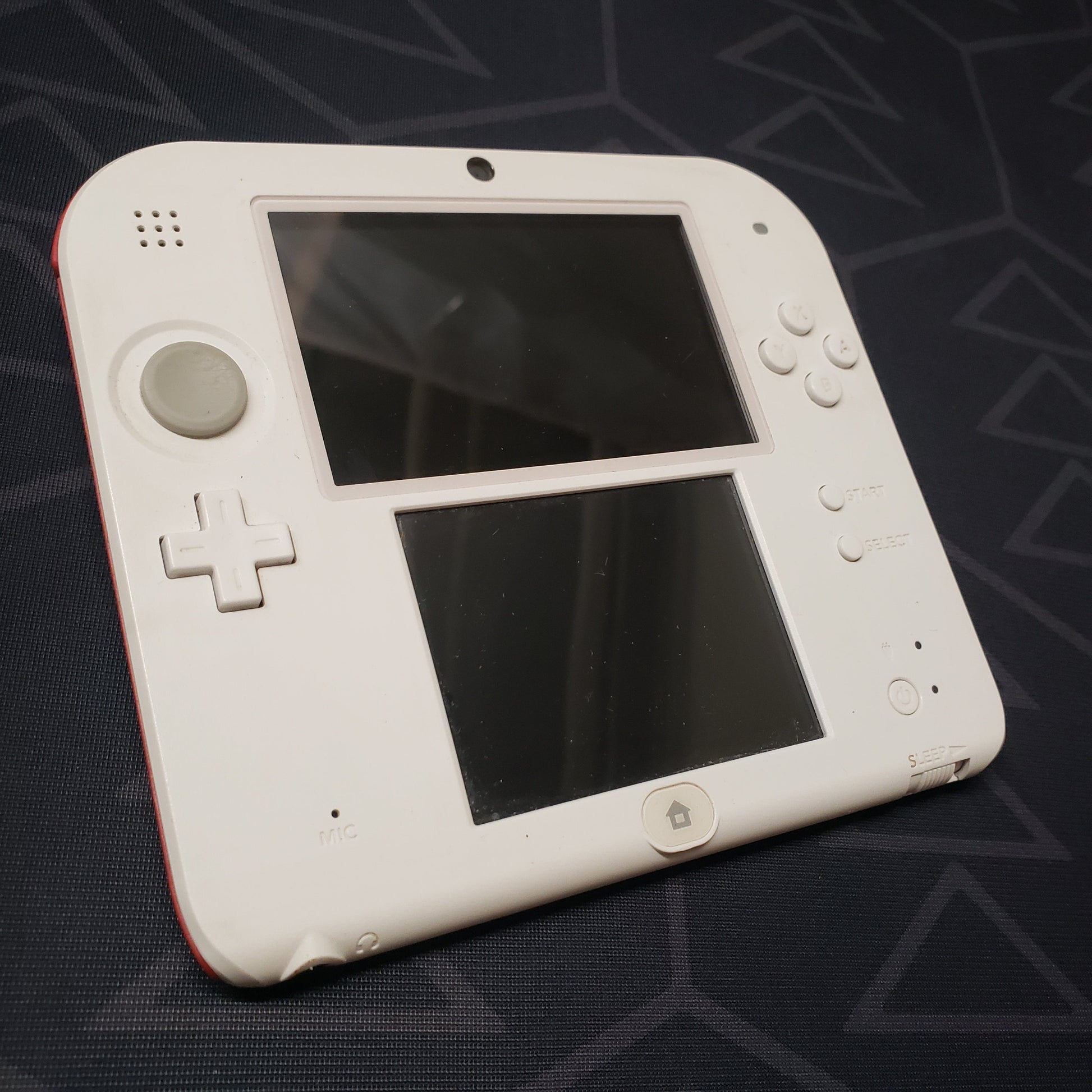 Image shows the front of a Nintendo 2DS: Scarlet Red gaming console