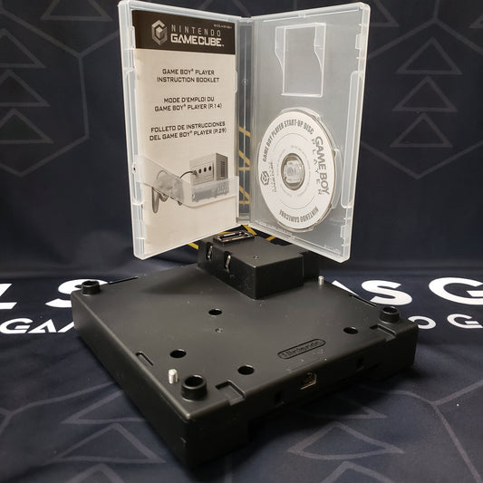 Image shows the boot disc in its case sitting on top of the Game Boy Player attchment for the Nintendo GameCube