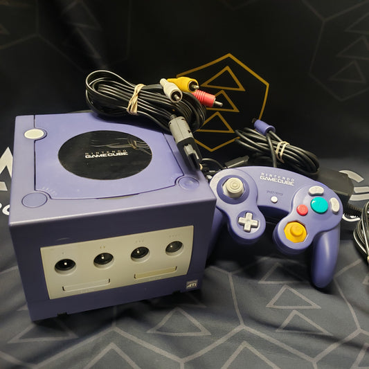 Image shows the front of an indigo Nintendo GameCube gaming console along with a controller and its cables