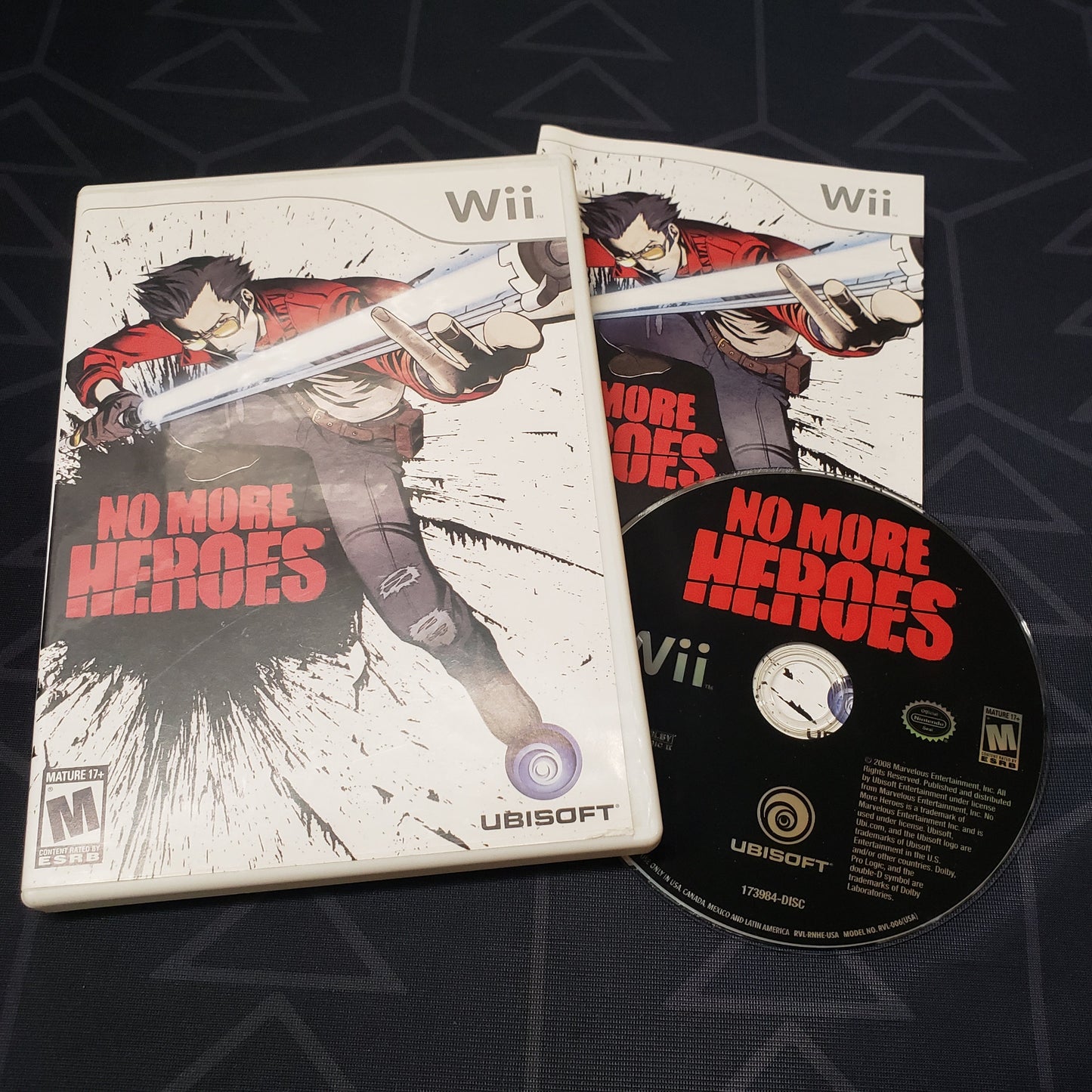 Image shows the case, manual and disc for the video game No More Heroes for Nintendo Wii