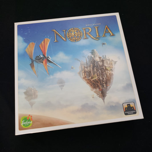 Image shows the front cover of the box of the Noria board game