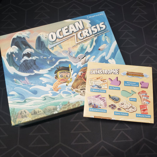 Image shows the front cover of the box for the Ocean Crisis board game with the instructions for the Catastrophe expansion sitting on top of it