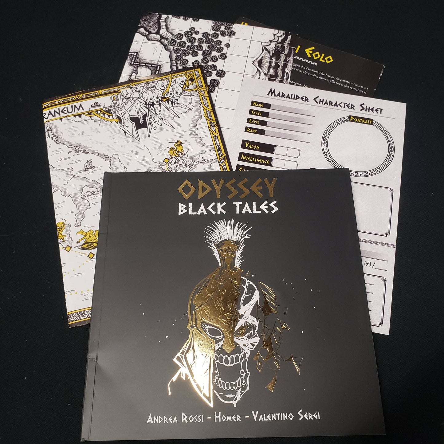 Image shows the front cover of the Odyssey: Black Tales roleplaying game book, along with various maps and character sheets