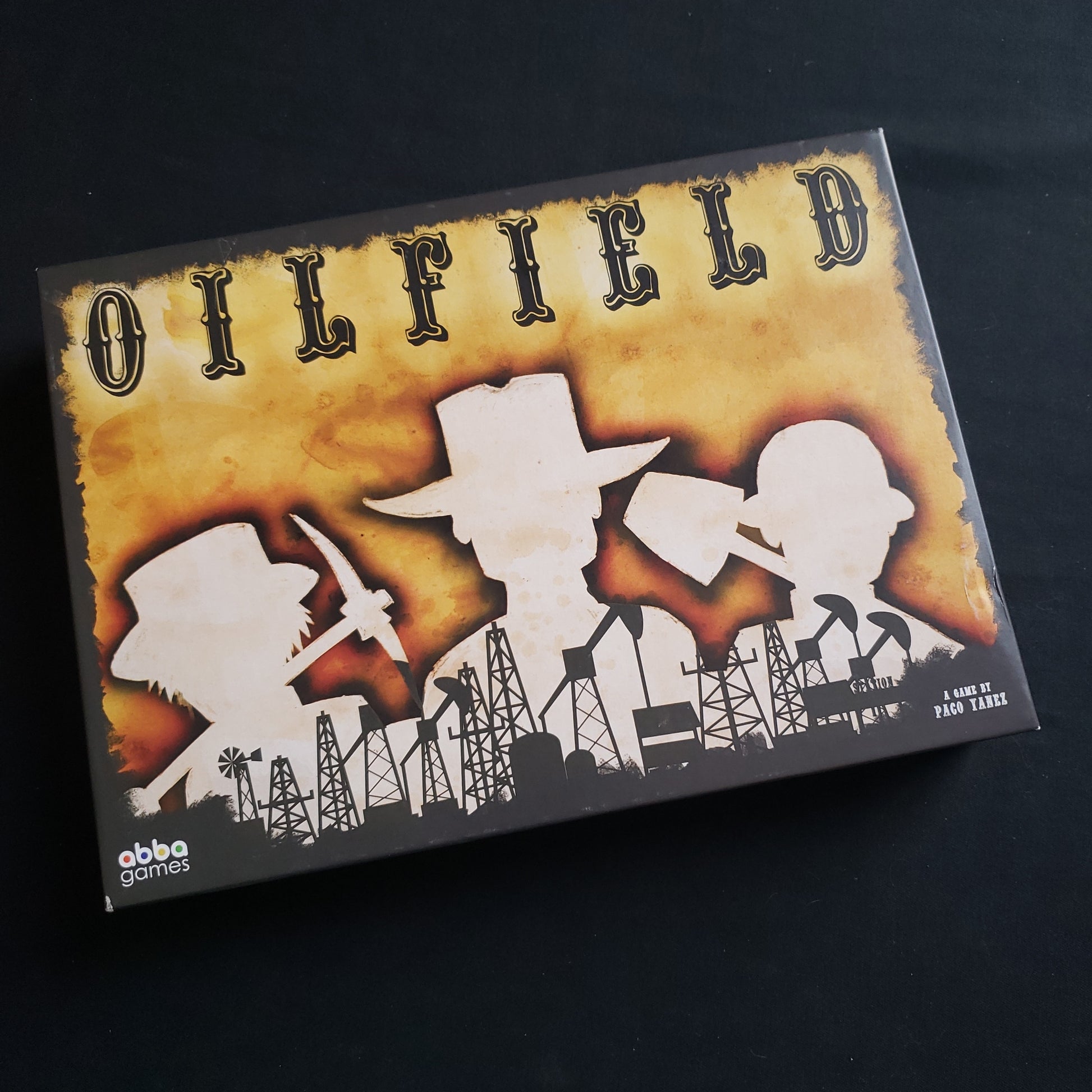 Image shows the front cover of the box of the Oilfield board game