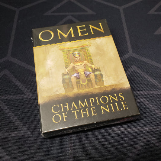 Image shows the front cover of the box of the Champions of the Nil expansion for the Omen Saga card games