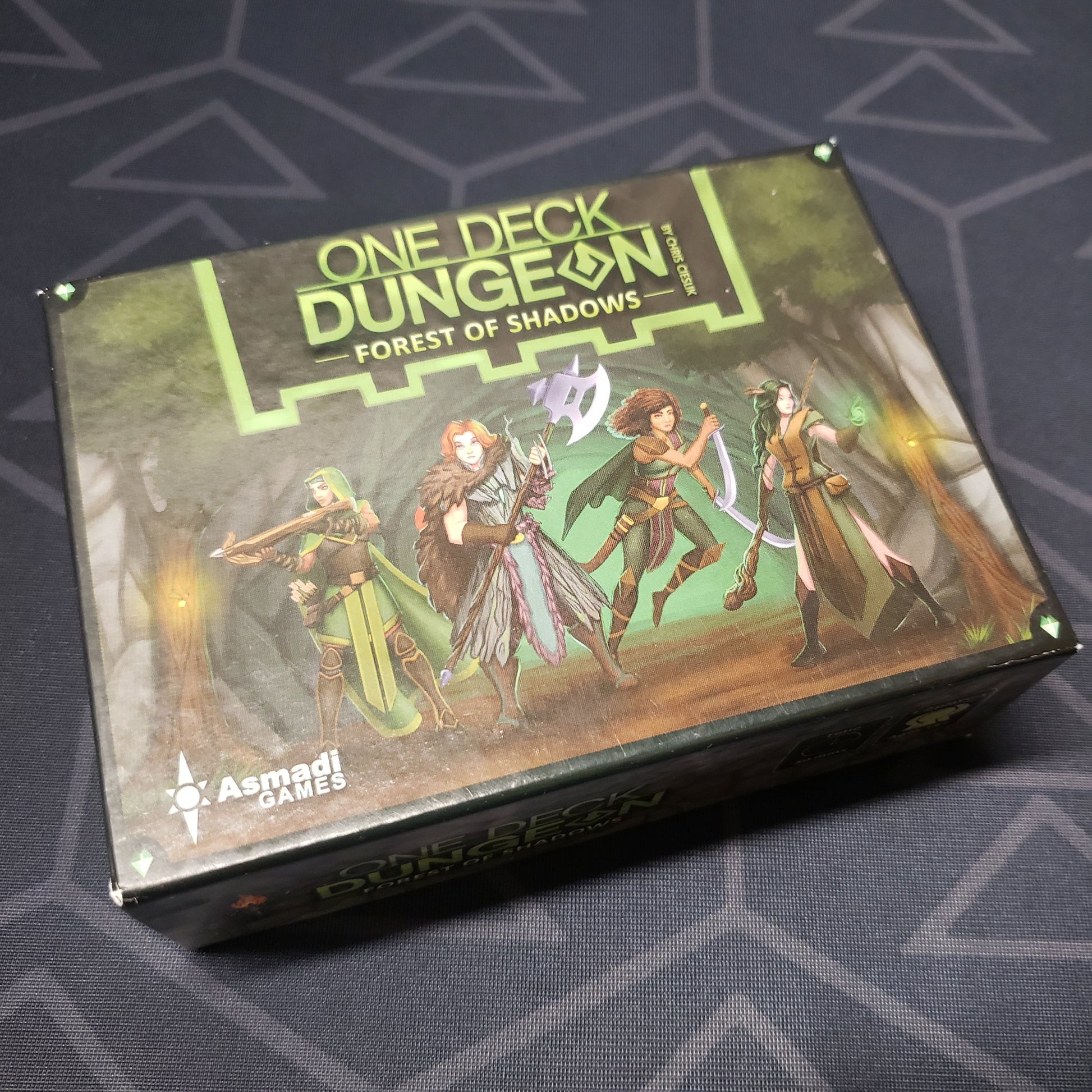 Image shows the front cover of the box of the One Deck Dungeon: Forest of Shadows board game