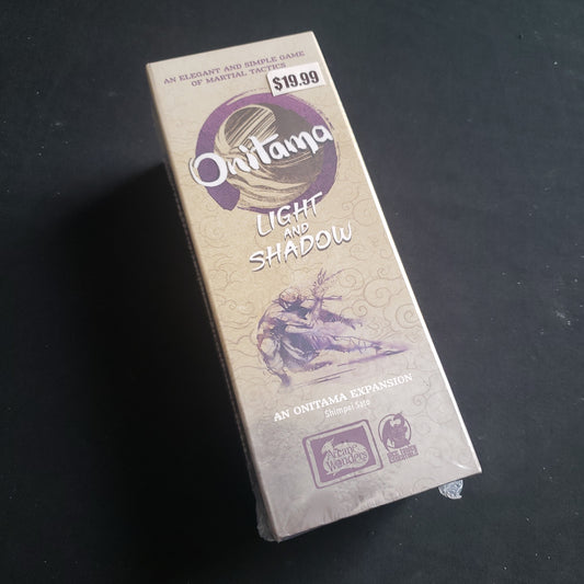 Image shows the front of the box for the Light & Shadow Expansion for the Onitama board game