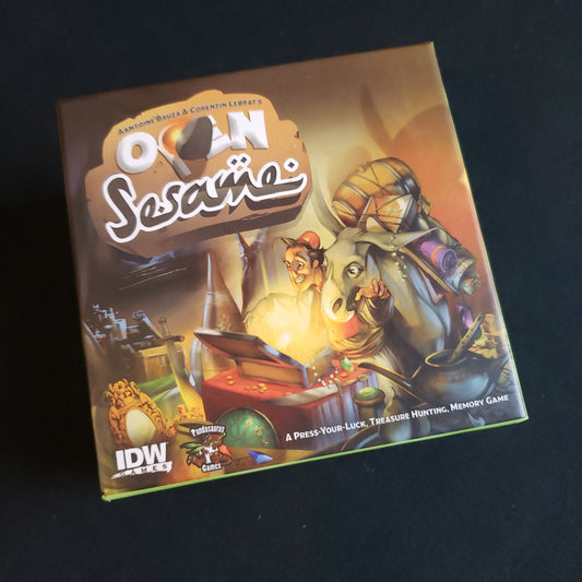 Image shows the front cover of the box of the Open Sesame card game