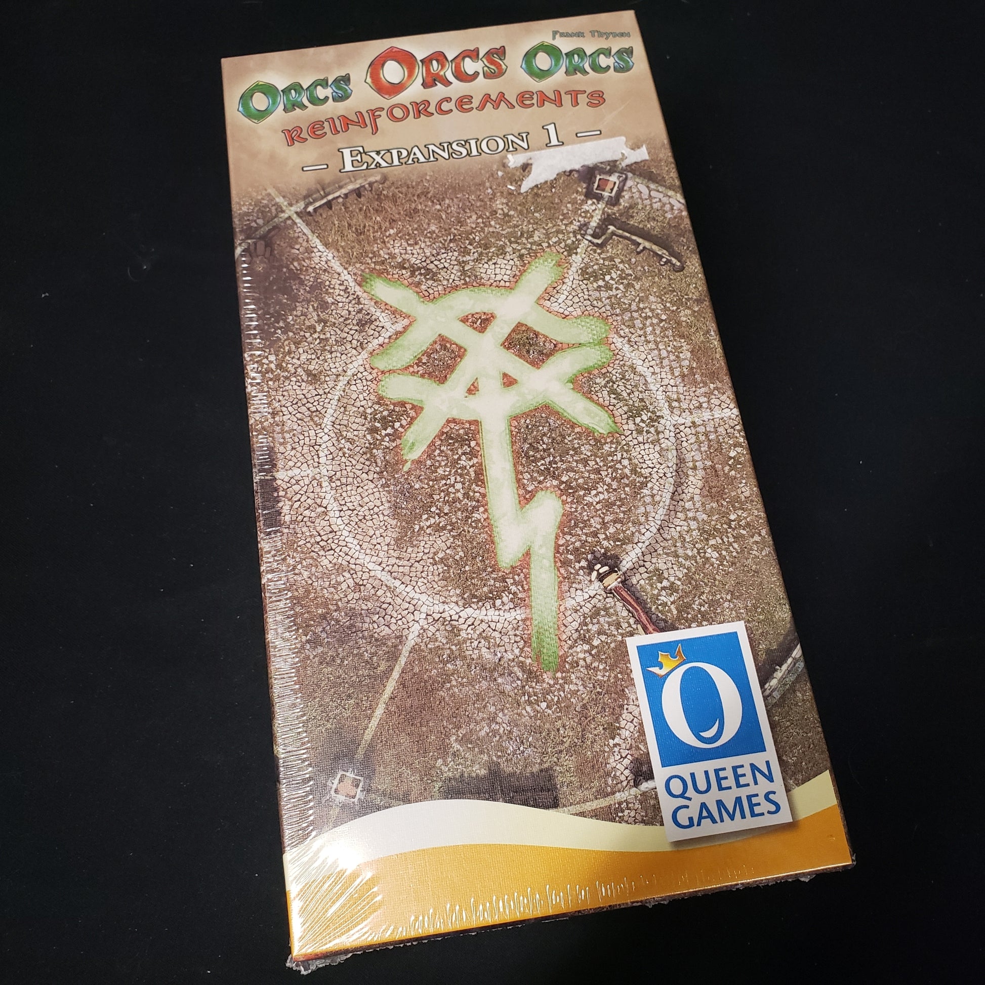 Image shows the front cover of the box of the Reinforcements expansion for the board game Orcs Orcs Orcs