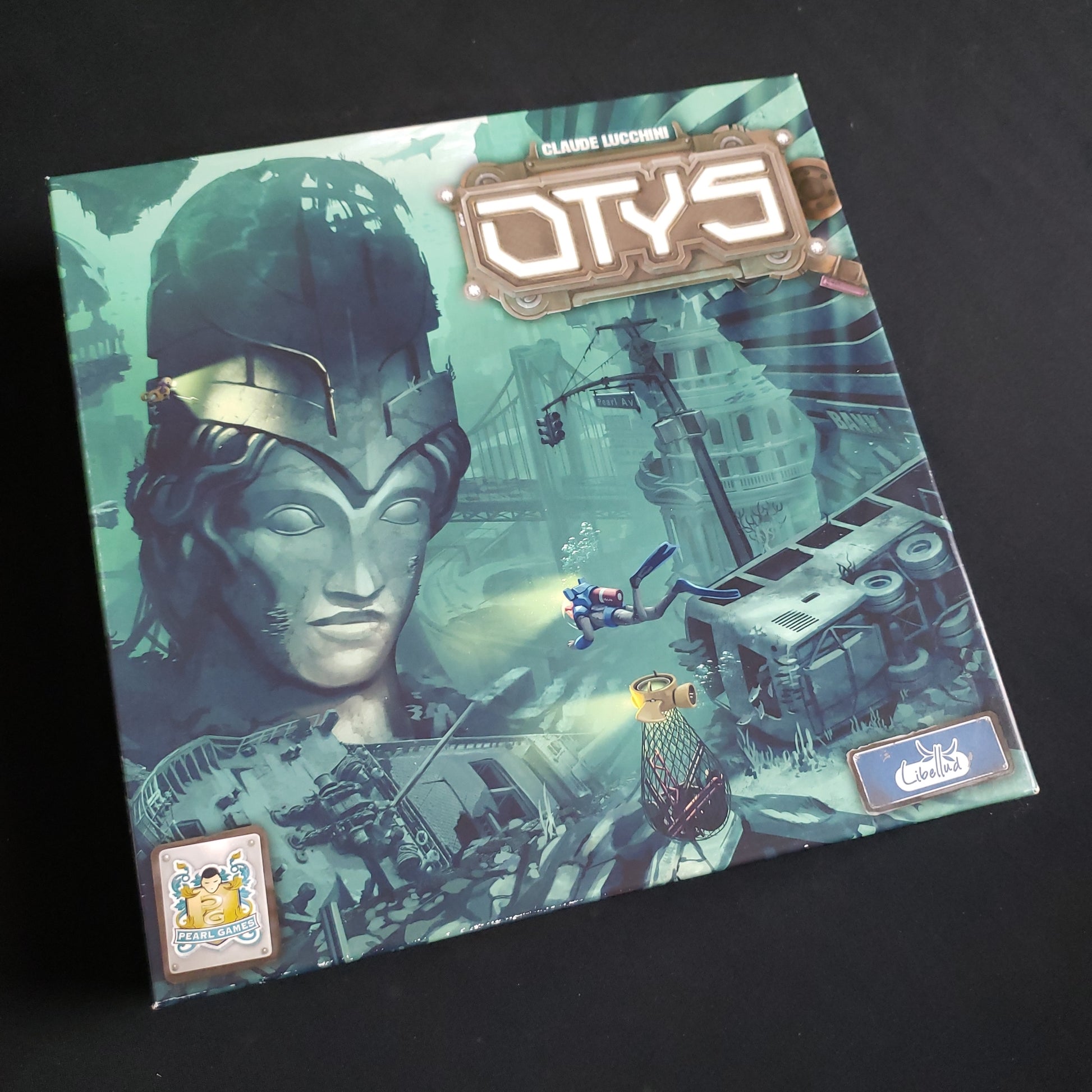 Image shows the front cover of the box of the Otys board game