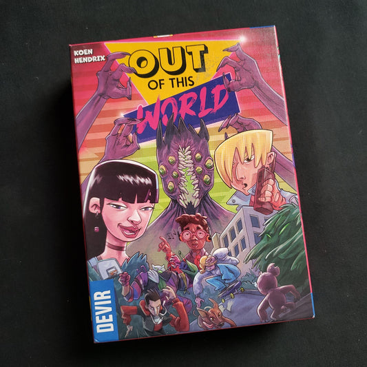 Image shows the front cover of the box of the Out Of This World card game