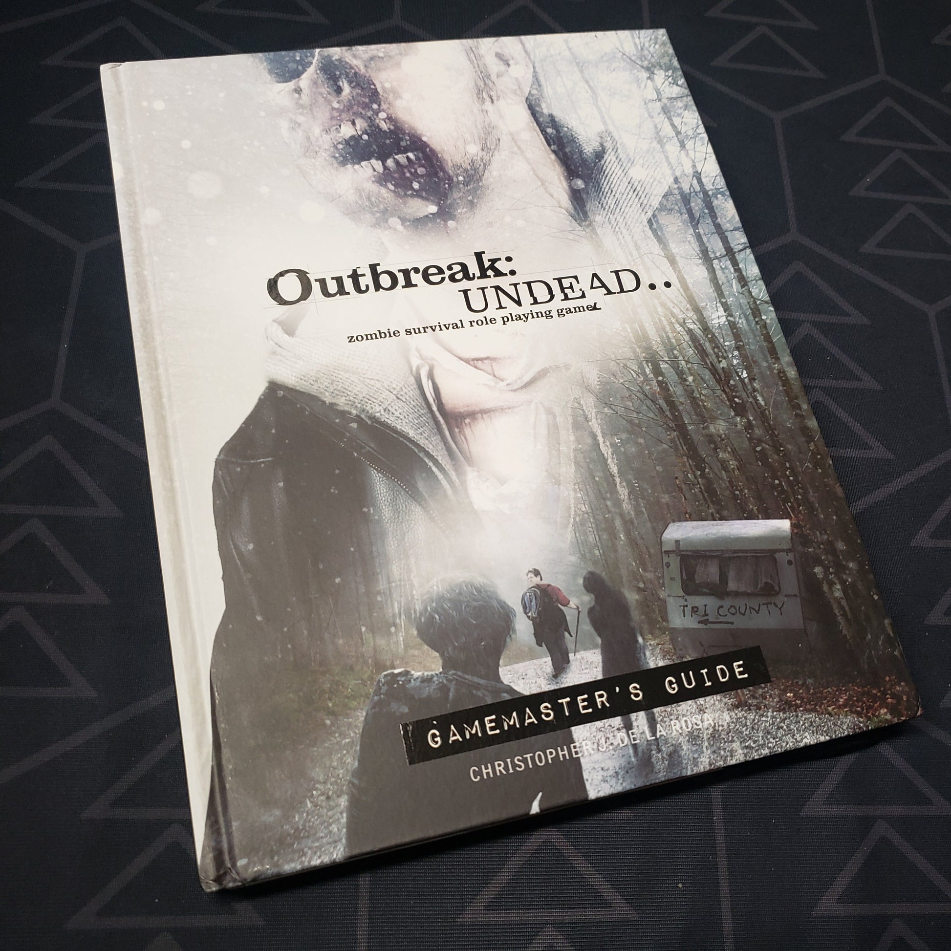 Image shows the front cover of the Gamemaster's Guide book for the roleplaying game Outbreak: Undead - Second Edition