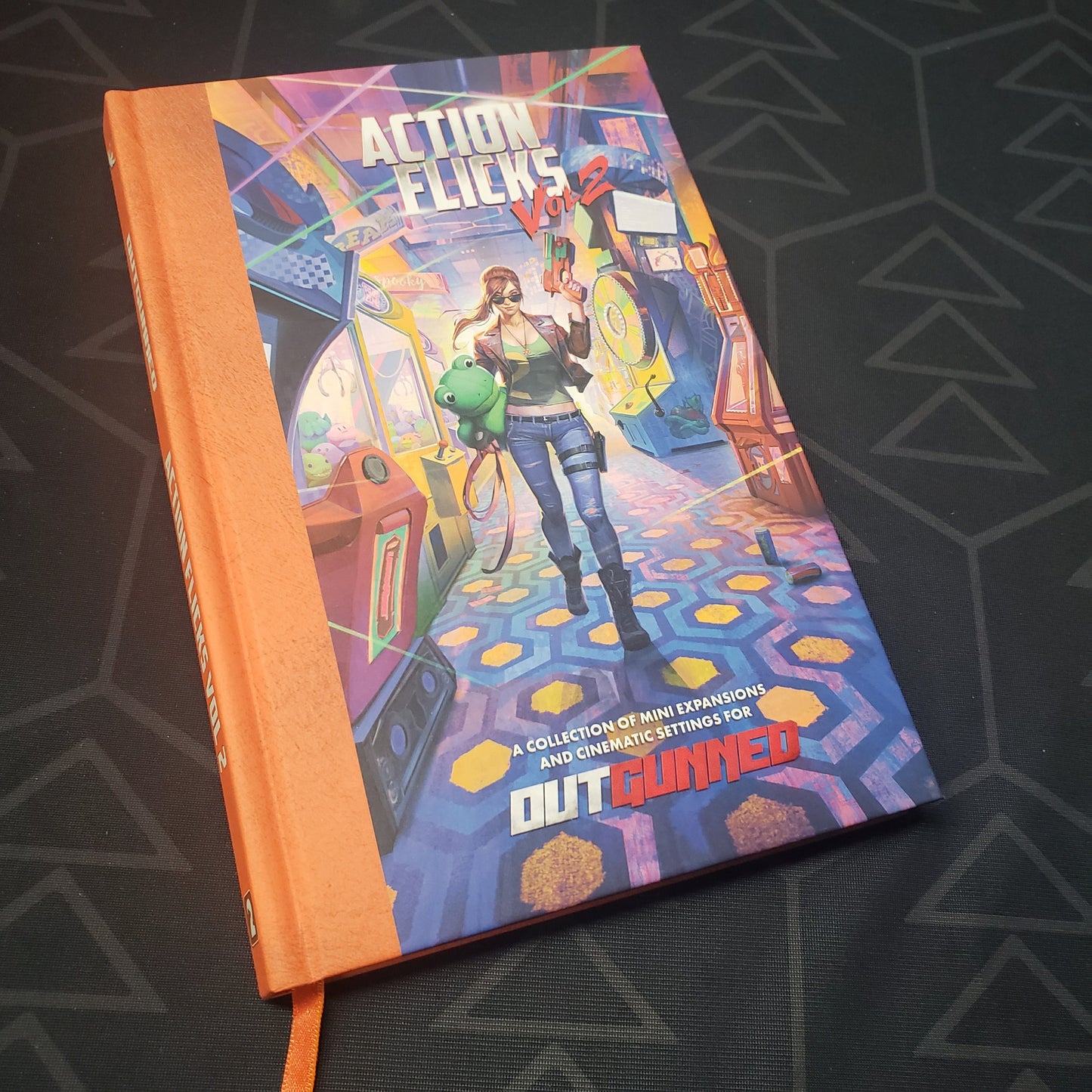 Image shows the front cover of the Action Flicks Vol. 2 book for the roleplaying game Outgunned