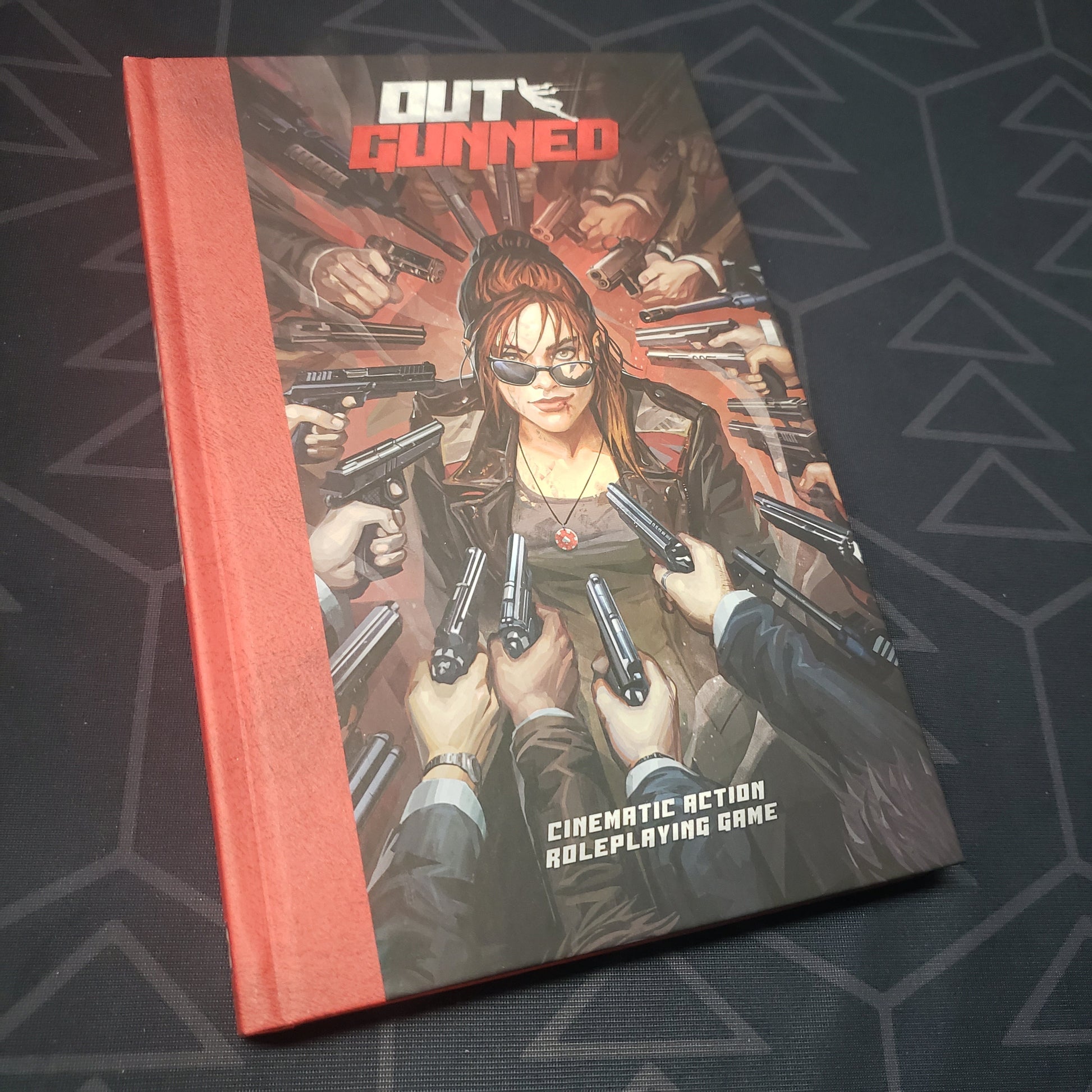 Image shows the front cover of the core rulebook for the roleplaying game Outgunned
