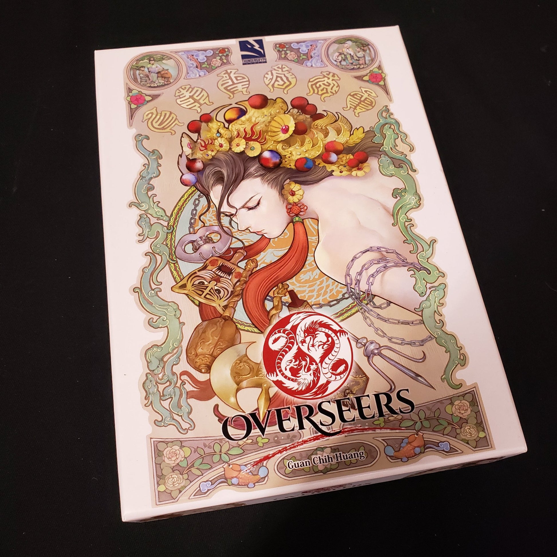 Image shows the front cover of the box of the Overseers board game