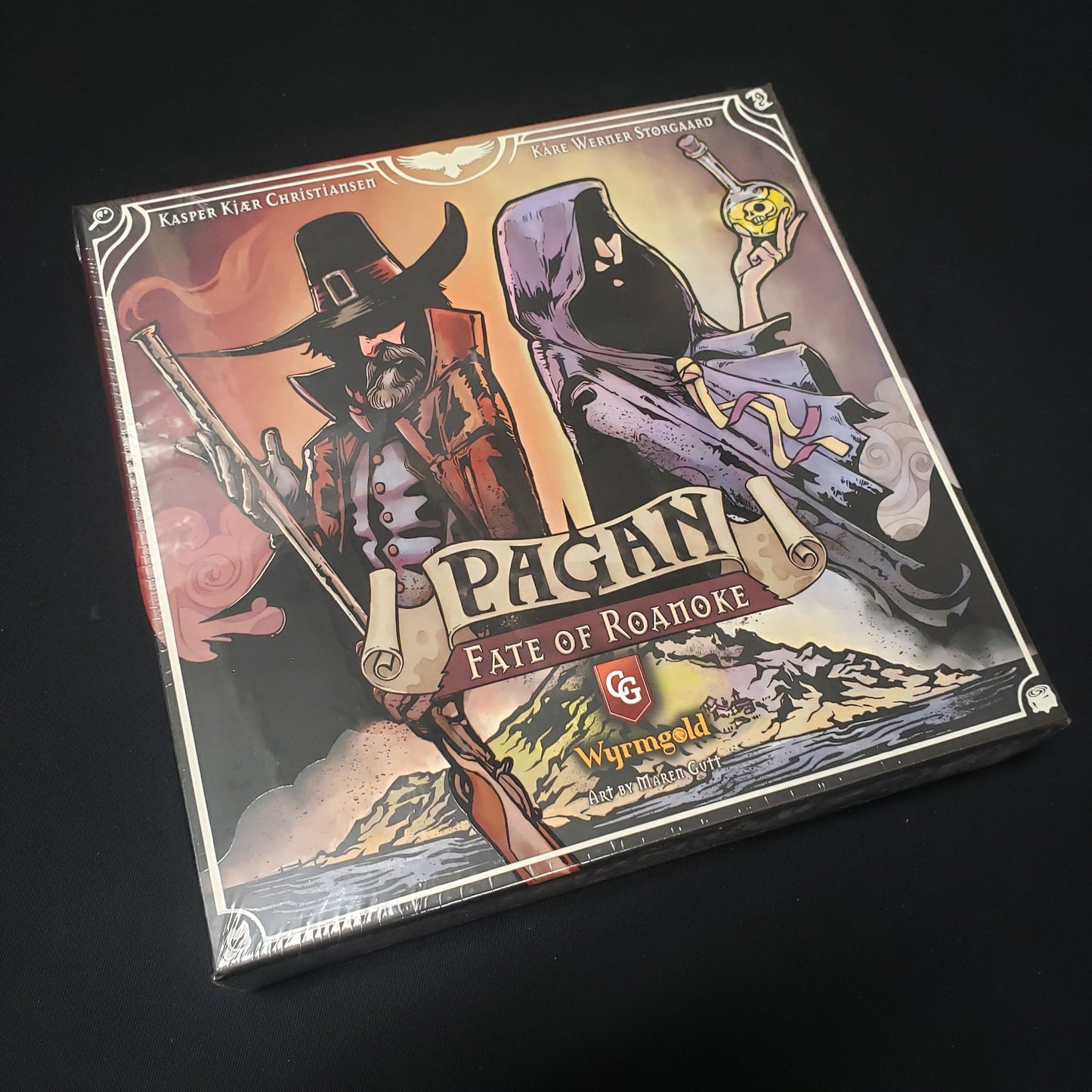 Image shows the front cover of the box of the Pagan: Fate of Roanoke board game