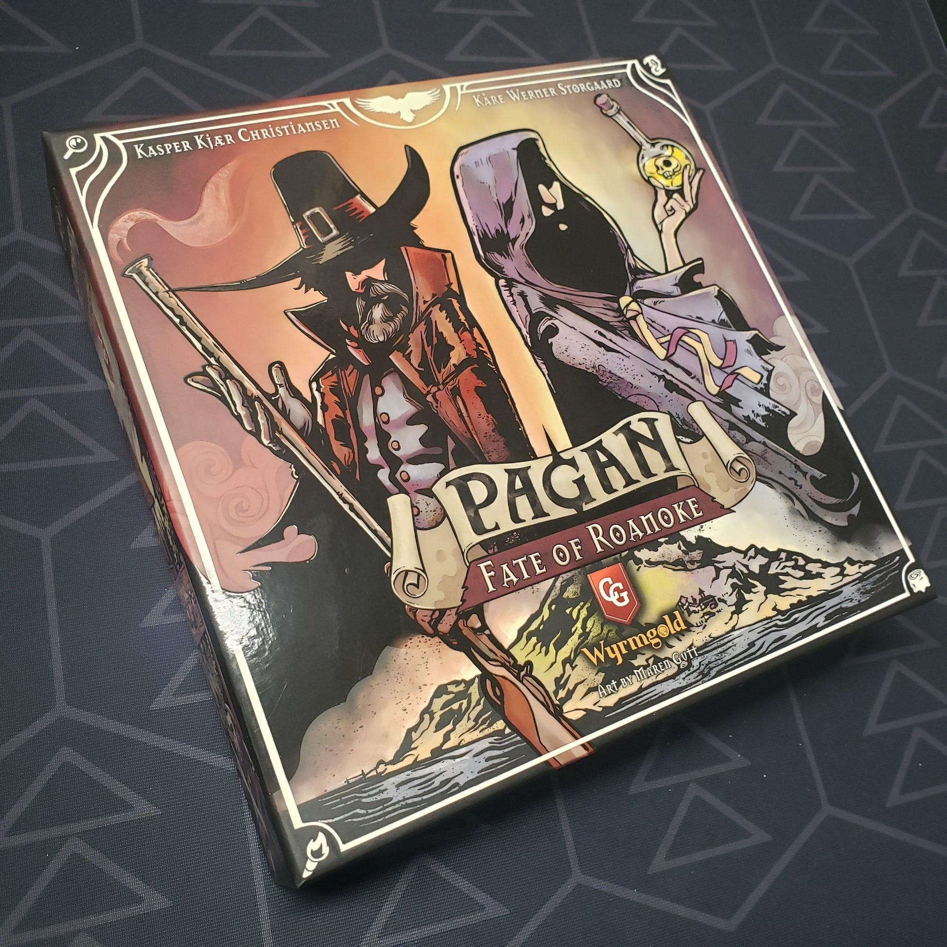 Image shows the front cover of the box of the Pagan: Fate of Roanoke card game