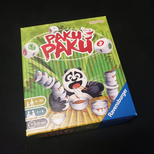 Image shows the front cover of the box of the Paku Paku board game