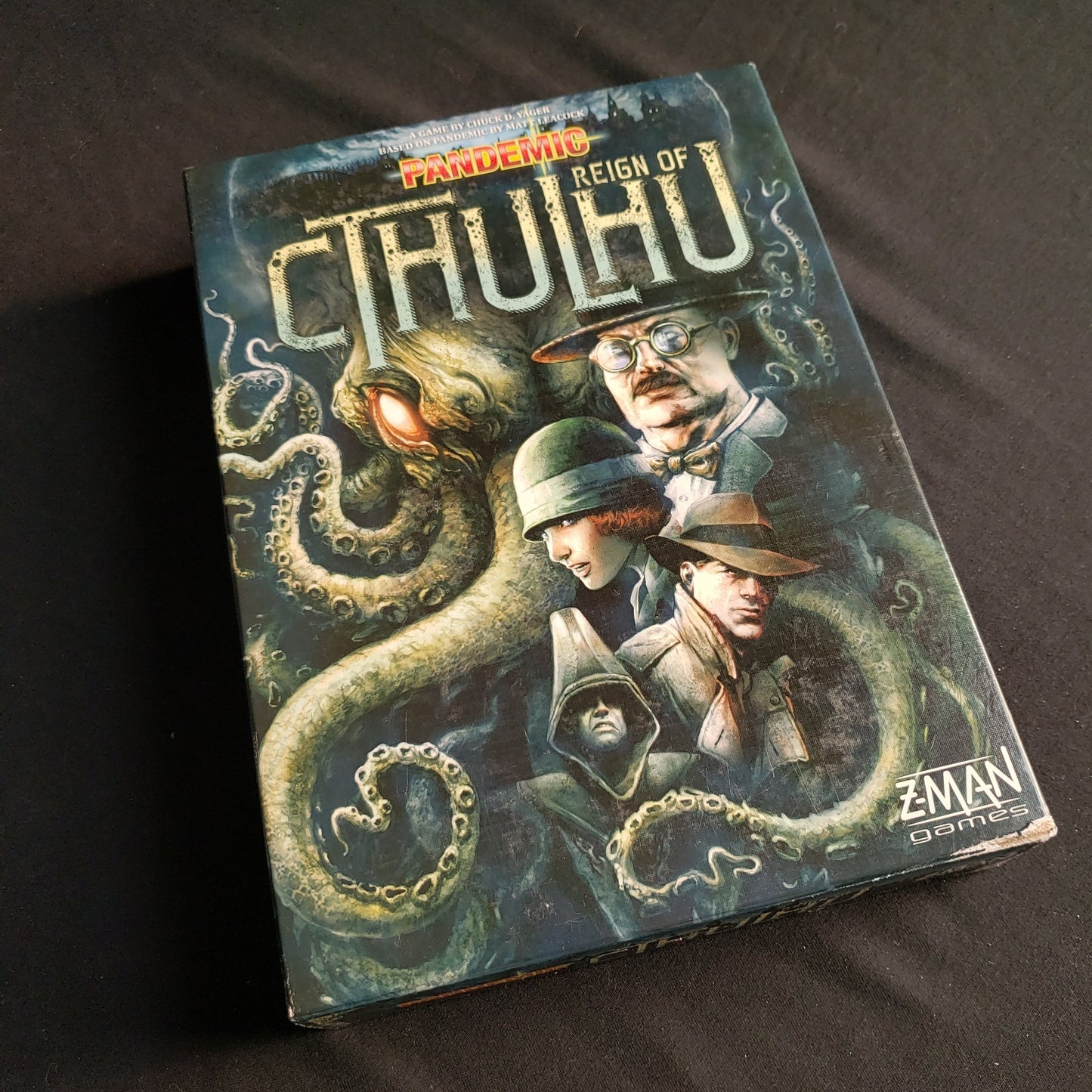 Image shows the front cover of the box of the Pandemic: Reign of Cthulhu board game