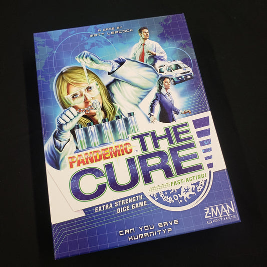 Image shows the front cover of the box of the Pandemic: The Cure board game