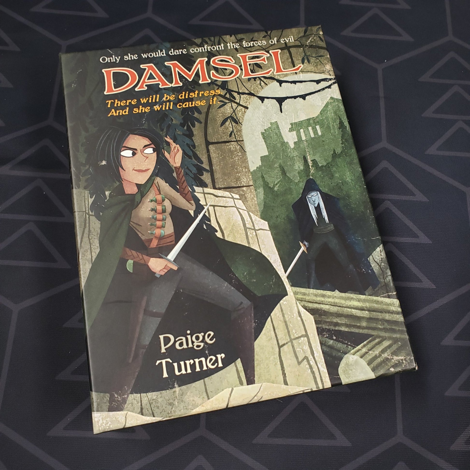 Image shows the front of the box for the Damsel character expansion for the card game Paperback Adventures