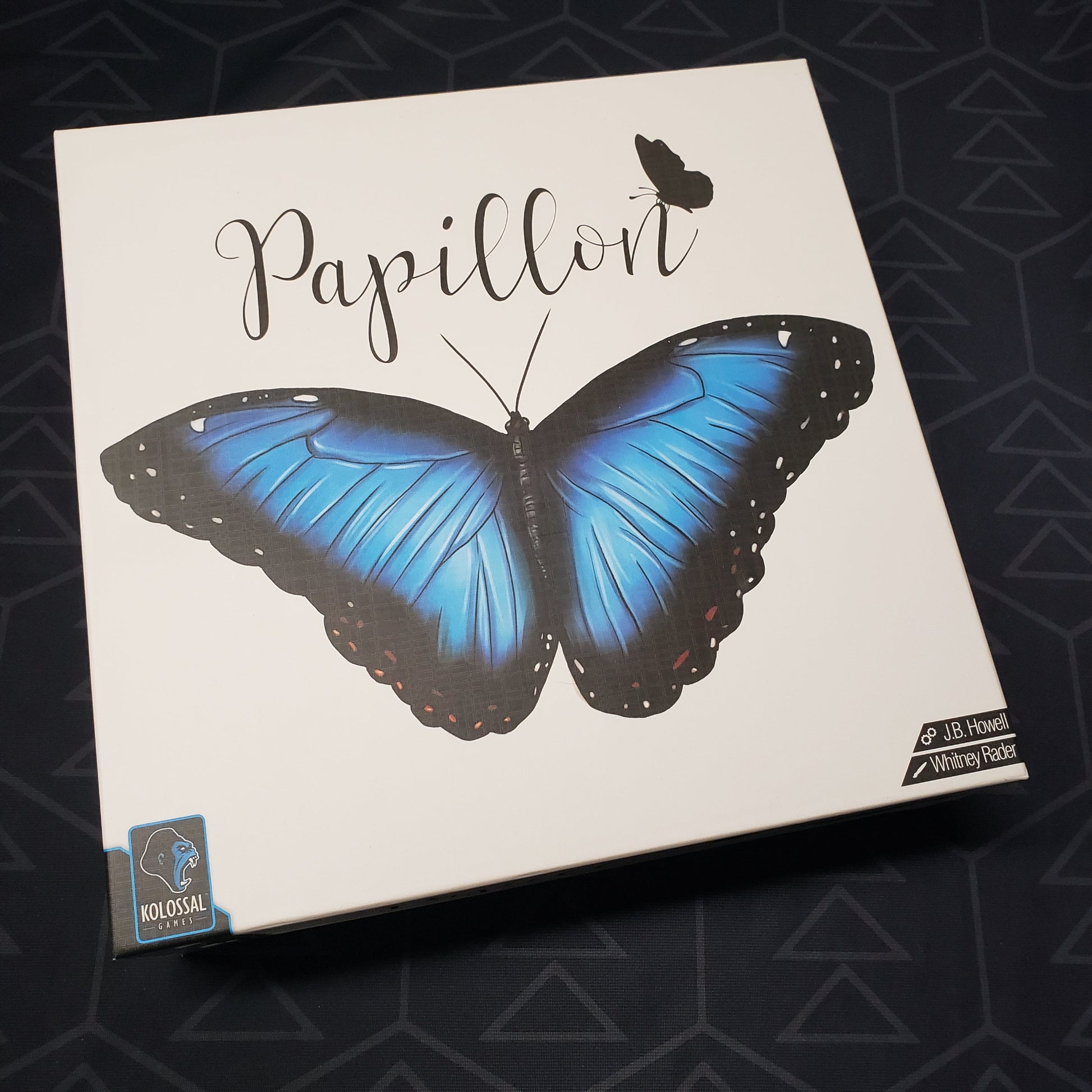 Image shows the front cover of the box for the Papillon board game