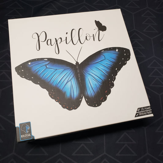 Image shows the front cover of the box for the Papillon board game