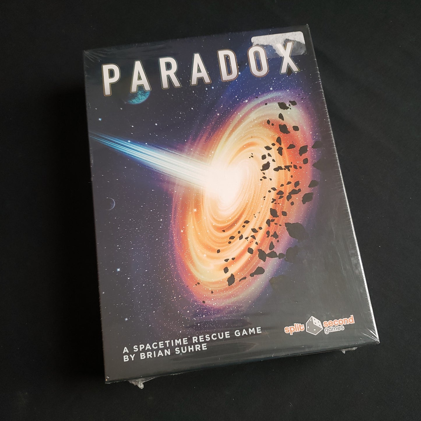 Image shows the front cover of the box of the Paradox board game