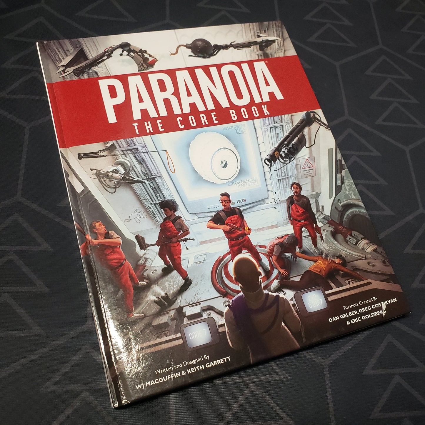 Image shows the front cover of the core rulebook for the roleplaying game Paranoia