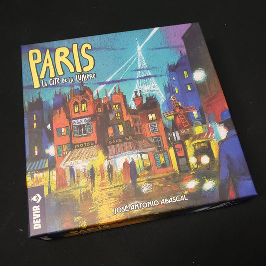 Image shows the front cover of the box of the Paris: La Cite de la Lumiere board game