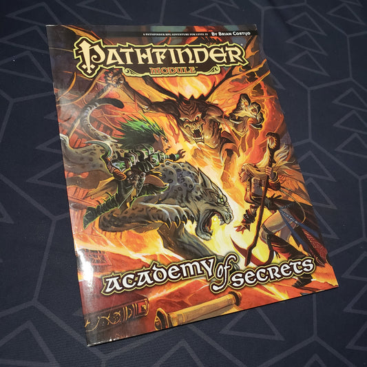 Image shows the front cover of the Academy of Secrets adventure module book for the roleplaying game Pathfinder 1E