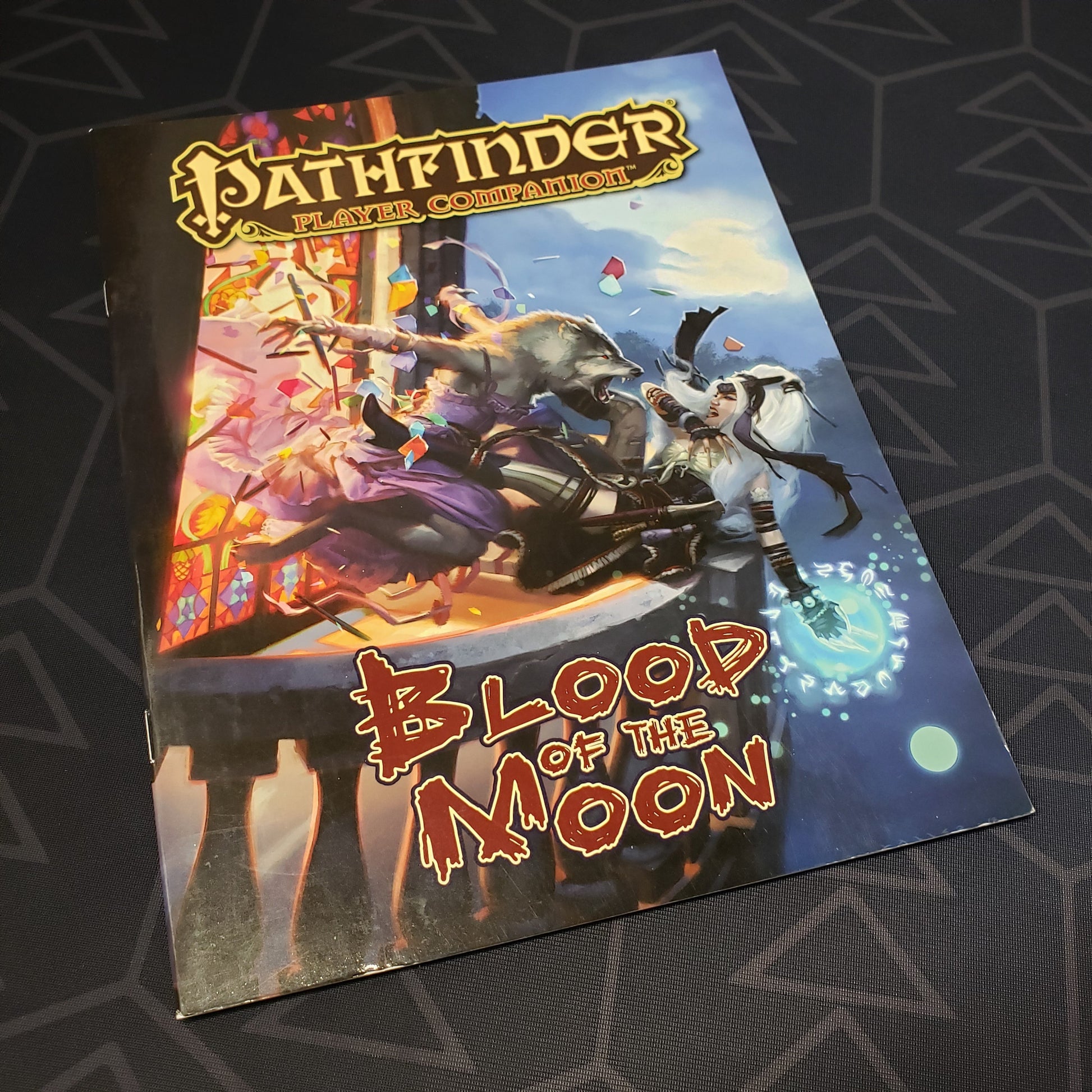 Image shows the front cover of the Blood of the Moon book for the roleplaying game Pathfinder: First Edition